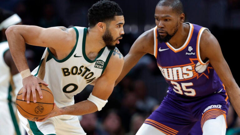 Boston Celtics forward Jayson Tatum (0) goes up against Phoenix Suns forward Kevin Durant (35) in the fourth quarter. The Celtics defeat the Suns, 127-112, at TD Garden.
