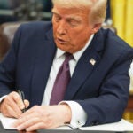 President Donald Trump signs an executive order.