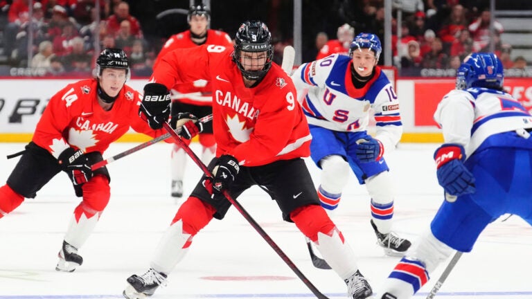 Canada's Gavin McKenna (9) skates with the puck as United States' Drew Fortescue (5) defends during the second period of an IIHF World Junior Hockey Championship tournament game in Ottawa, Ontario, Dec. 31, 2024.