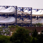 Giant wind turbine blades for the Vineyard Winds project are stacked on racks.