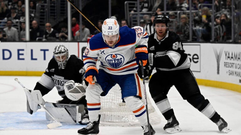 Edmonton Oilers left wing Viktor Arvidsson (33) controls the puck against Los Angeles Kings defenseman Vladislav Gavrikov (84) and goaltender Darcy Kuemper (35) during the third period of an NHL hockey game in Los Angeles, Saturday, April 5, 2025.