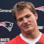 New England Patriots quarterback Drake Maye listens to a reporter's question during an NFL football practice, Monday, June 9, 2025, in Foxborough, Mass.