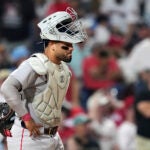 Red Sox catcher Carlos Narváez waits for umpires to call catcher's interference on him during an at-bat by Philadelphia Phillies' Edmundo Sosa with the bases loaded during the 10th inning.