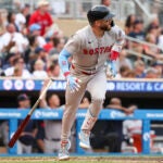 Trevor Story of the Red Sox watches his two run home run against the Minnesota Twins during the third inning.