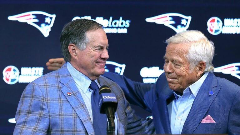 New England Patriots owner Robert Kraft (right) pats the back of former head coach Bill Belichick after he addressed the media at Gillette Stadium about his departure.
