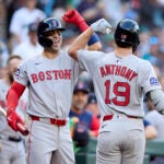 Boston Red Sox's Roman Anthony (19) is greeted by Marcelo Mayer, left, after hitting a solo home run off Seattle Mariners starting pitcher Logan Gilbert during the first inning of a baseball game Monday, June 16, 2025, in Seattle.