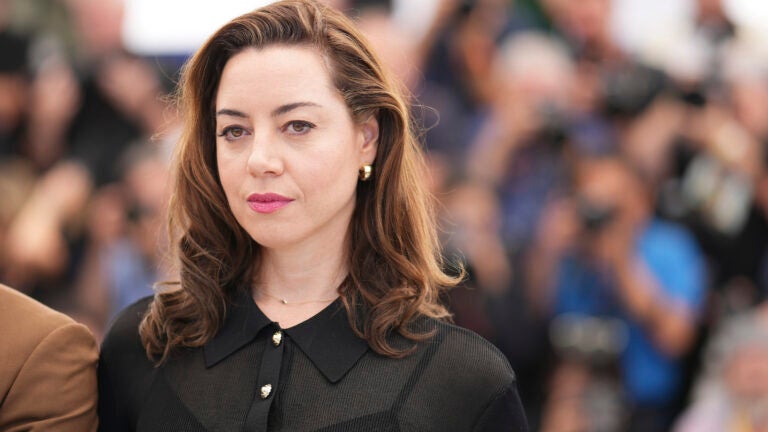 Aubrey Plaza poses for photographers.