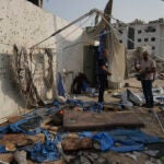 Palestinian inspect the destroyed tent where journalists, including Al Jazeera correspondents Anas al-Sharif and Mohamed Qureiqa, were killed by an Israeli airstrike outside the Gaza City's Shifa hospital complex Monday, Aug. 11, 2025.