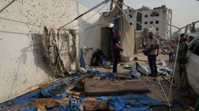 Palestinian inspect the destroyed tent where journalists, including Al Jazeera correspondents Anas al-Sharif and Mohamed Qureiqa, were killed by an Israeli airstrike outside the Gaza City's Shifa hospital complex Monday, Aug. 11, 2025.