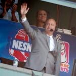 Sports announcer Don Orsillo waves from the broadcast booth following a video tribute during the eighth inning of a baseball game between the Boston Red Sox and the Baltimore Orioles in Boston, Sunday, Sept. 27, 2015.