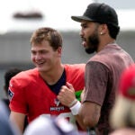New England Patriots quarterback Drake Maye (10) greets Boston Celtic star Jayson Tatum after today’s joint training camp practice with the Washington Commanders in Foxborough, MA.