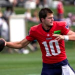 New England Patriots quarterback Drake Maye (10) warms up during today’s joint training camp practice with the Washington Commanders in Foxborough, MA.