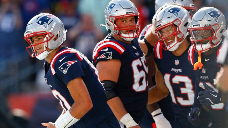 New England Patriots quarterback Drake Maye (10) celebrates a touchdown throw to wide receiver Mack Hollins (13) during the fourth quarter on Sept. 28, 2025, at Gillette Stadium.