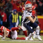 Patriots WR Julian Edelman looks for some more yardage after picking up a key first down in the overtime period on a pass reception from quarterback Tom Brady. The New England Patriots visited the Kansas City Chiefs for the AFC Championship Game at Arrowhead Stadium.