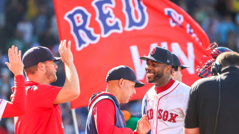 Aroldis Chapman #44 of the Boston Red Sox with manager Alex Cora after they defeated the Pittsburgh Pirates 5-2 during MLB action at Fenway Park on Saturday August 30, 2025.