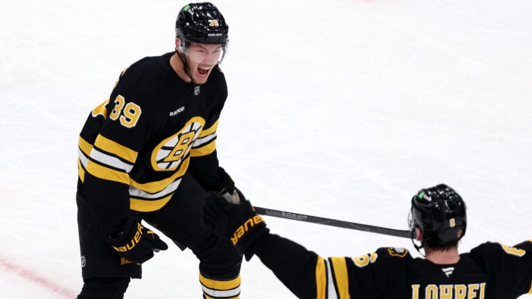 Boston Bruins forward Morgan Geekie celebrates his second period goal with teammate Mason Lohrei during a hockey game against the Colorado Avalanche, Saturday, Oct. 25, 2025, in Boston.