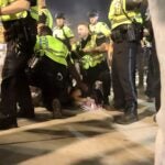 Police detain a demonstrator during a pro-Palestinian protest on Boston Common.