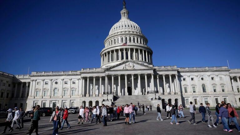 People walk on the East Front at the U.S. Capitol.