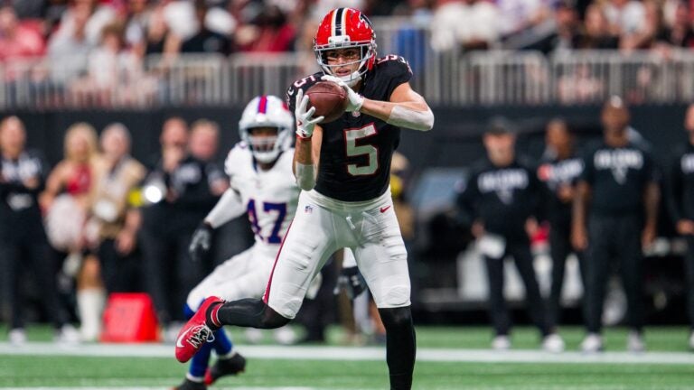 Falcons wide receiver Drake London catches a pass with separation from a defender behind him.