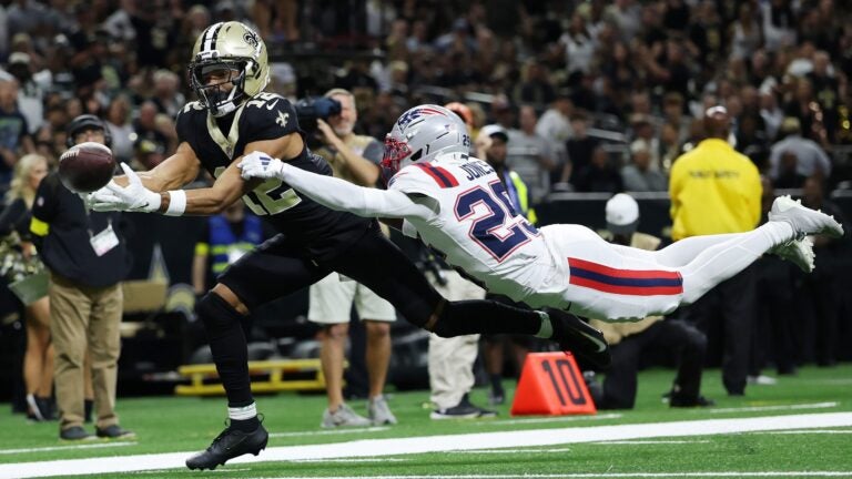NEW ORLEANS, LOUISIANA - OCTOBER 12: Chris Olave #12 of the New Orleans Saints attempts to catch a pass against Marcus Jones #25 of the New England Patriots during the second quarter at Caesars Superdome on October 12, 2025 in New Orleans, Louisiana.