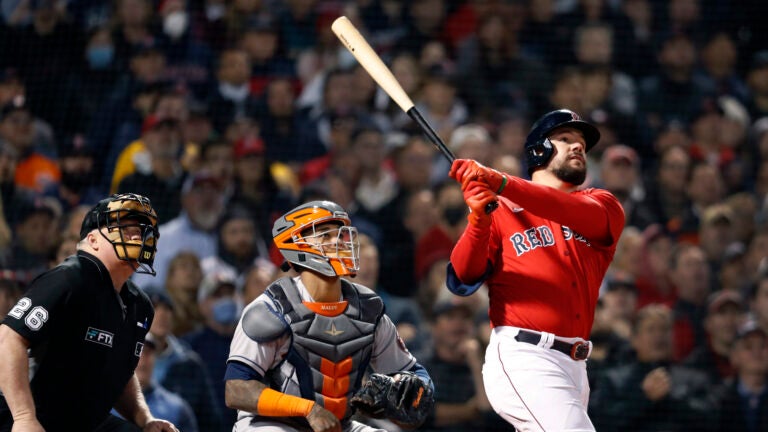 The Red Sox Kyle Schwarber , along with Astros catcher Martin Maldonado and home plate umpire Bill Miller watch the flight of his bottom of the second inning grand slam home run. The Boston Red Sox hosted the Houston Astros for Game Three of the ALCS at Fenway Park.