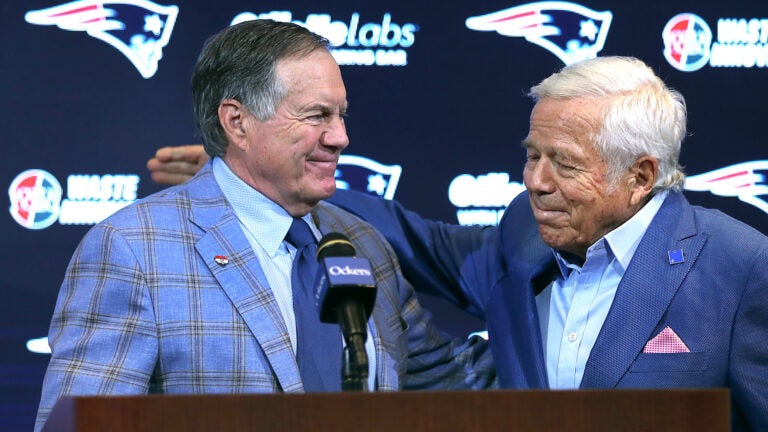 New England Patriots owner Robert Kraft (right) pats the back of former head coach Bill Belichick after he addressed the media at Gillette Stadium about his departure.