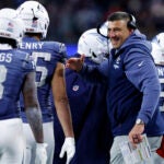 New England Patriots head coach Mike Vrabel celebrates with tight end Hunter Henry (85) and wide receiver Stefon Diggs (8) after a touchdown by running back TreVeyon Henderson (32) during the third quarter. The New England Patriots played the New York Jets at Gillette Stadium on November 13, 2025.