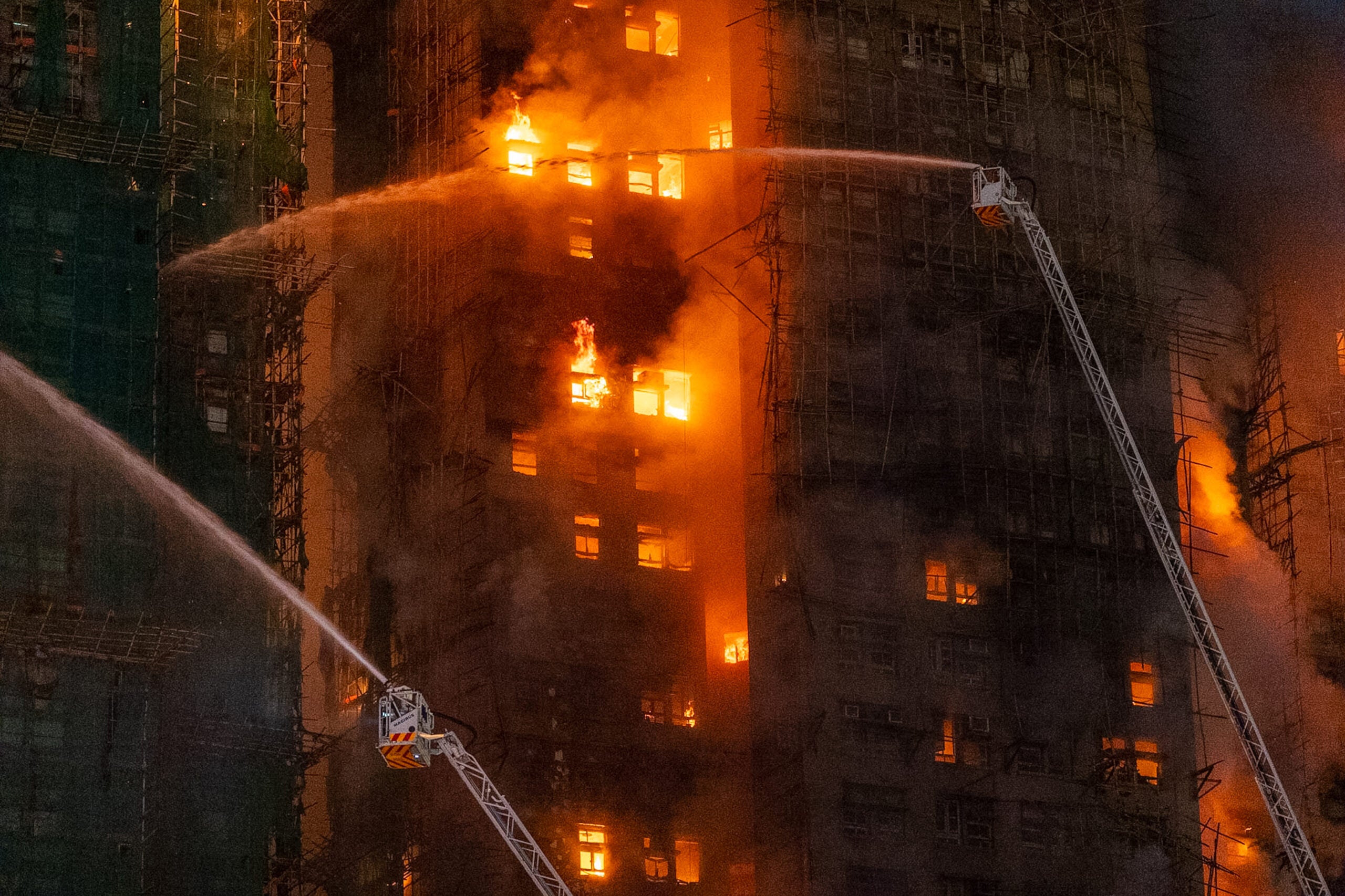 Firefighters try to extinguish a flames engulfing a building after a fire broke out at Wang Fuk Court, a residential estate in the Tai Po district of Hong Kong's New Territories. 