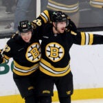 Boston Bruins center Fraser Minten, left, and Boston Bruins left wing Tanner Jeannot, right, celebrate after Jeannot's goal during the second period of an NHL hockey game against the Chicago Blackhawks, Thursday, Oct. 9, 2025, in Boston.