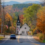 Fall foliage colors the scene near the Community Church in Sugar Hill, N.H.