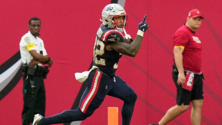 New England Patriots running back TreVeyon Henderson (32) celebrates after scoring a touchdown against the Tampa Bay Buccaneers during the second half of an NFL football game Sunday, Nov. 9, 2025, in Tampa, Fla.