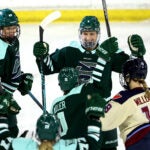 Fleet team captain Megan Keller, top right, celebrates her second period goal with teammates Shay Maloney, left, and Alina Müller during the season opener against Montreal at Tsongas Center on Sunday, November 23, 2025.
