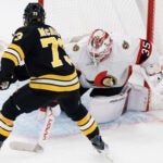 Ottawa Senators goaltender Linus Ullmark stops a shot by Boston Bruins' Charlie McAvoy.