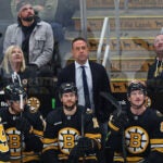 All eyes are on a video replay board, including Boston Bruins head coach Marco Sturm (center) during an NHL hockey game against the Colorado Avalanche, Saturday Oct. 25, 2025, in Boston.