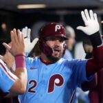 Philadelphia Phillies' Kyle Schwarber reacts after hitting a two-run home run against Atlanta Braves pitcher Austin Cox during the fourth inning of a baseball game Thursday, Aug. 28, 2025, in Philadelphia.