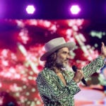 Russell Brand speaks during Turning Point USA's AmericaFest 2025.