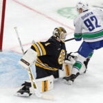 Boston Bruins goalie Jeremy Swayman couldn't stop the puck as the Vancouver Canucks Liam Ohgren scored in the shootout with a goal that eventually gave Vancouver a 5-4 victory during an NHL hockey game, Saturday, Dec. 20, 2025, in Boston.