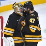 Boston Bruins goaltender Jeremy Swayman (1) celebrates with center Mark Kastelic (47) after the Bruins beat the New Jersey Devils in an NHL hockey game, Saturday, Dec. 6, 2025, in Boston.