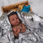 A doll representing the baby Jesus is zip-tied in the Nativity scene outside of Lake Street Church of Evanston.