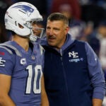 New England Patriots quarterback Drake Maye (10) talks with head coach Mike Vrabel prior to the start of an NFL football game against the New York Jets, Thursday, Nov. 13, 2025, in Foxborough, Mass.