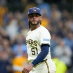 Milwaukee Brewers pitcher Freddy Peralta walks to the dugout after the top of the fifth inning in Game 2 of baseball's National League Championship Series against the Los Angeles Dodgers, Tuesday, Oct. 14, 2025, in Milwaukee.