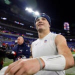 New England Patriots quarterback Drake Maye (10) throws a towel to fans after defeating the Baltimore Ravens. The New England Patriots played the Baltimore Ravens at M&T Bank Stadium on Dec. 21, 2025.