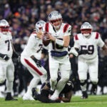 New England Patriots quarterback Drake Maye (10) is sacked by Baltimore Ravens defensive end Dre'Mont Jones during the first half of an NFL football game, Sunday, Dec. 21, 2025, in Baltimore.