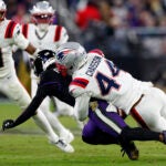 New England Patriots linebacker K'Lavon Chaisson (44) knocks the ball out of the hands of Baltimore Ravens wide receiver Zay Flowers (4) resulting in Patriots possession during the fourth quarter. The New England Patriots played the Baltimore Ravens at M&T Bank Stadium on Dec. 21, 2025.