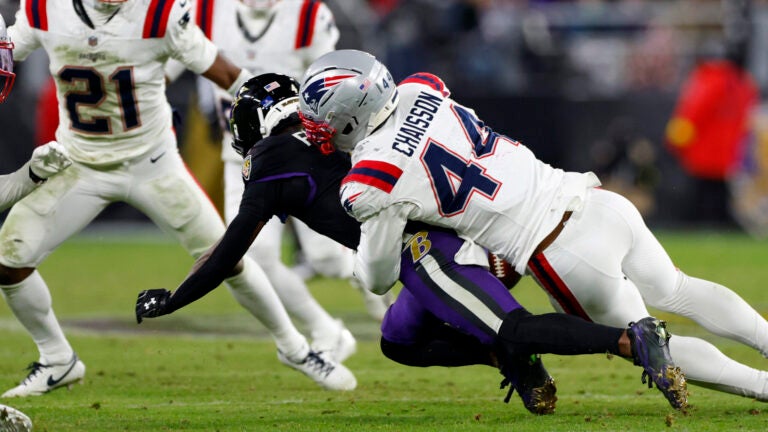 New England Patriots linebacker K'Lavon Chaisson (44) knocks the ball out of the hands of Baltimore Ravens wide receiver Zay Flowers (4) resulting in Patriots possession during the fourth quarter. The New England Patriots played the Baltimore Ravens at M&T Bank Stadium on Dec. 21, 2025.