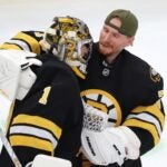 Boston Bruins' Joonas Korpisalo celebrates with Jeremy Swayman (1) after the Bruins defeated the Buffalo Sabres during an NHL hockey game, Saturday, Oct. 11, 2025, in Boston.