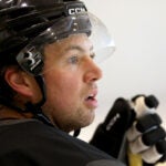 Charlie McAvoy watches his teammates skate during Bruins captains’ practice at Warrior Ice Arena on Tuesday, September 2, 2025.