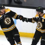 Boston Bruins right wing David Pastrnak (88)(left) is congratulated by Boston Bruins defenseman Charlie McAvoy (73) after his 2nd period goal.