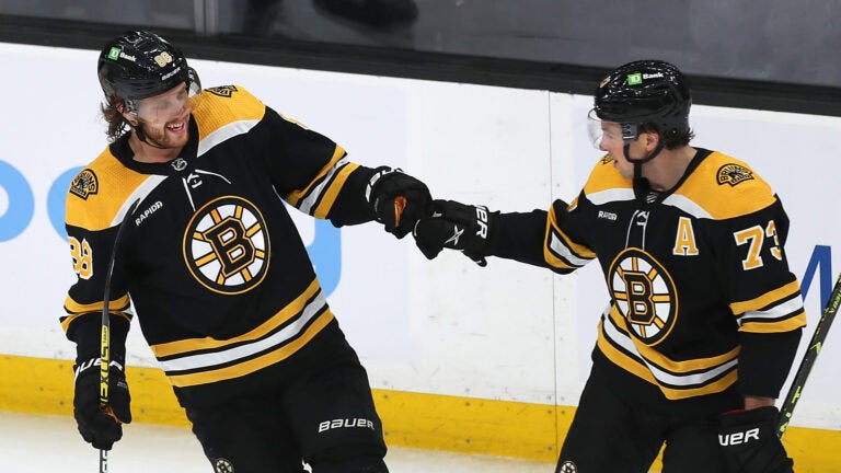 Boston Bruins right wing David Pastrnak (88)(left) is congratulated by Boston Bruins defenseman Charlie McAvoy (73) after his 2nd period goal.