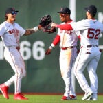 Sox outfielders (left to rt) Boston Red Sox outfielder Jarren Duran (16), Boston Red Sox shortstop Ceddanne Rafaela (3) and Boston Red Sox outfielder Wilyer Abreu (52) join in. agroup hug at the end of the game in which the Sox won 13-9.